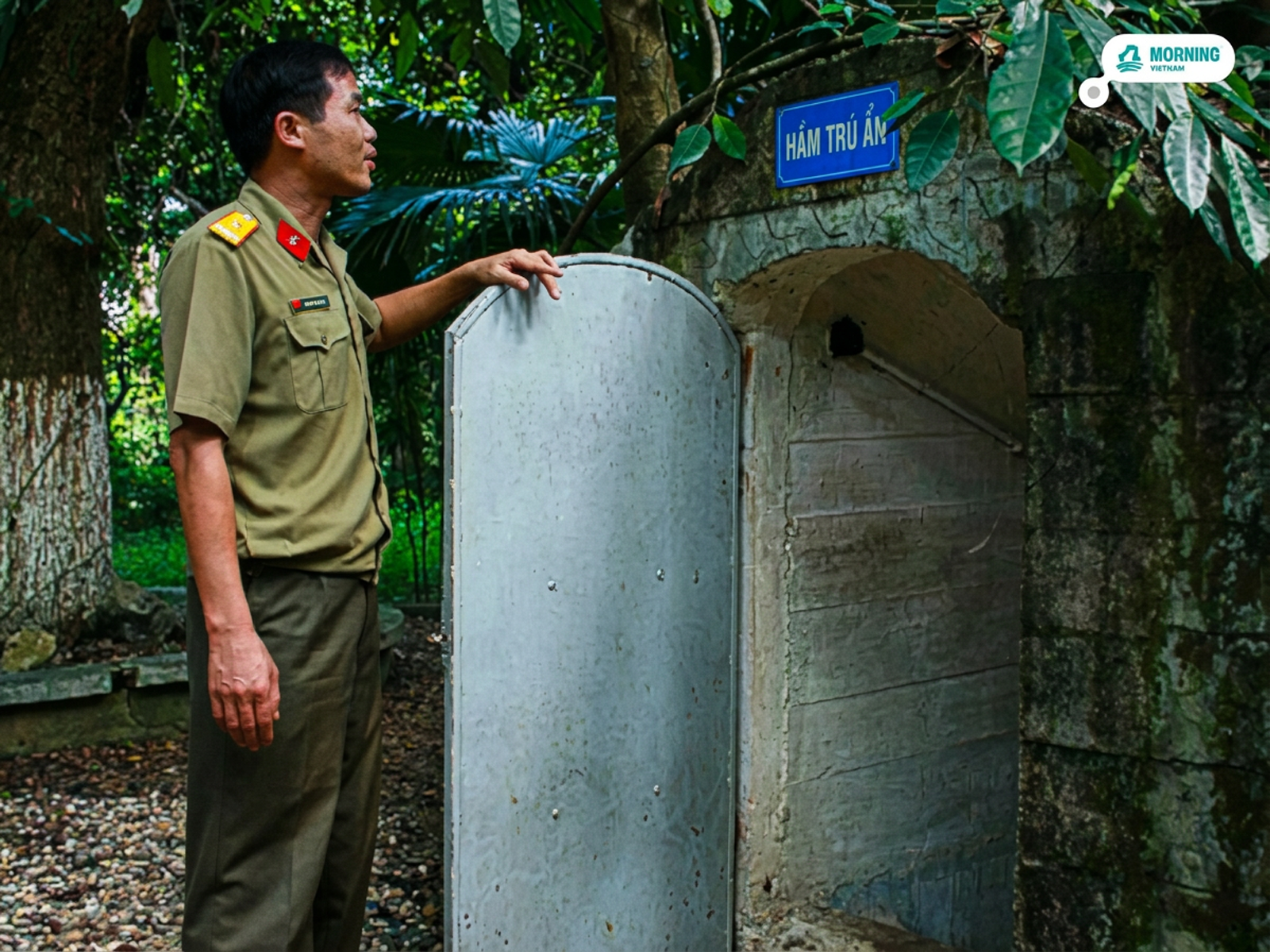 Guard at the underground bomb shelter entrance (Hầm trú ẩn) in the complex